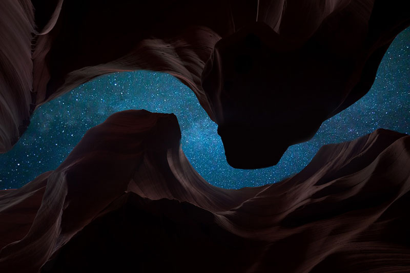 Night sky and stars seen through gap in a rock canyon, photo by Pexels.