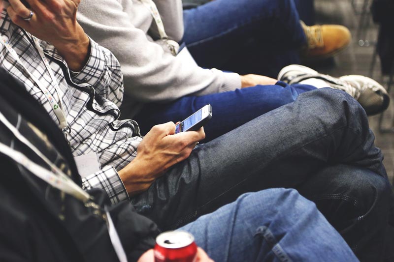 Photo of a person looking at smartphone