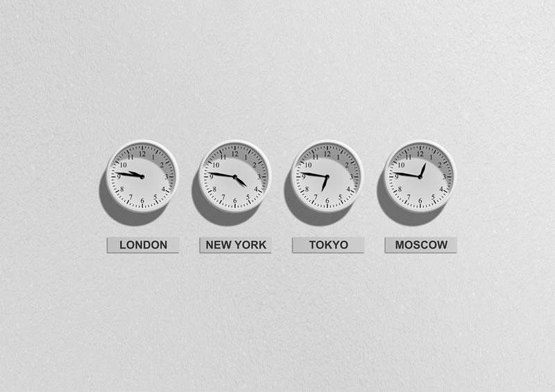 Photo of four clocks with different time zone times
